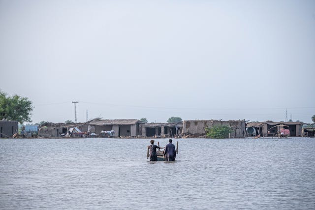 People standing knee-deep in flood water