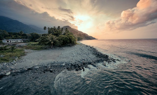 Serene coastal landscape with dramatic sunset